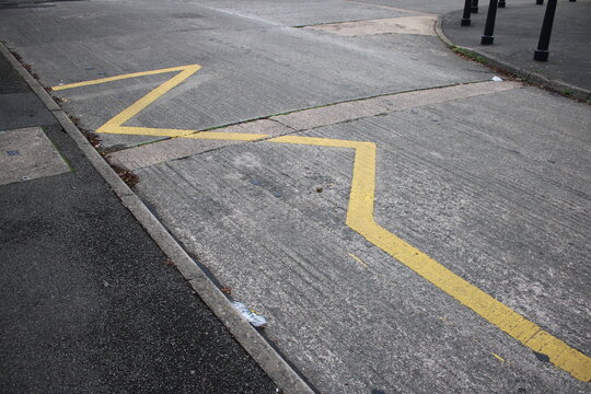 Yellow Zig Zag lines UK indicating to motorists to keep clear, no parking taken outside school entrance