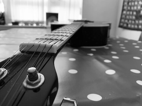 A 6 String acoustic guitar close up picture focused on the guitar head