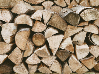 A close up picture taken from an outdoor log store full of seasoned cut wood ready to burn