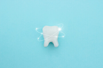 Protective vortex around tooth model on blue , teeth will good healthy.