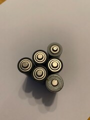Top view of a bunch of AA batteries against a white background