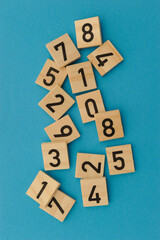 wooden tiles with numbers, math and numerology concept
