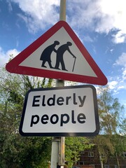 UK Road sign Elderly people with red triangle elderly people symbol