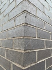Corner of a black brick wall, perspective focus
