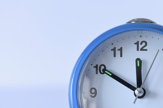 Alarm clock close-up. soft violet background. Time concept. Copyspace