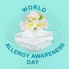 World Allergy Awareness Day observed on October 16. Poster with teal inscription, white surgery mask and white flowers on plain light turquoise blue background