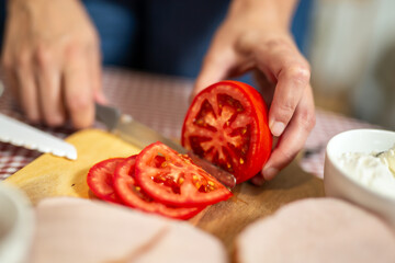Making a sandwich. Cutting groceries with knife. Spreading sour cream on the toast