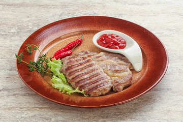 Grilled pork neck steak with ketchup