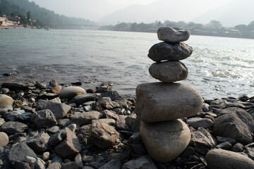 Balancing stone riverside cairn concept