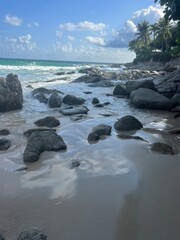 Waves on the seashore with rocks and stones. Horizon of sky and sea