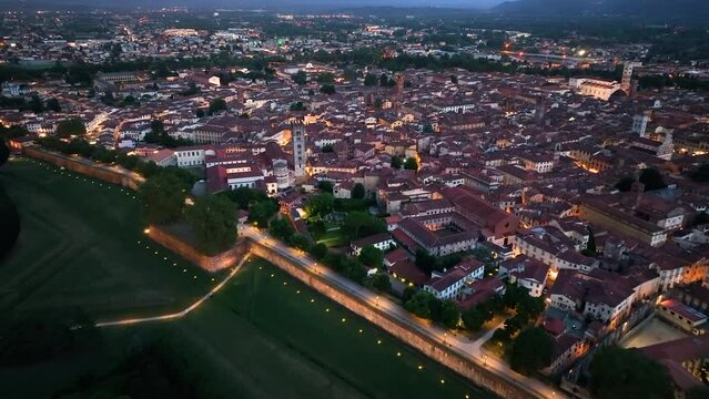 Sunset aerial shot of Lucca, showcasing its preserved walls and iconic landmarks, Tuscany, Italy