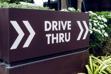 Drive thru sign in fast food restaurant. Drive thru sign into the shop. Drive through and takeaway for buy fast food for protect covid19 Concept.