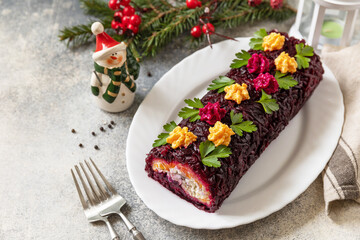 Festive layered shuba salad. Traditional Russian Christmas New Year vegetable salad roll with...