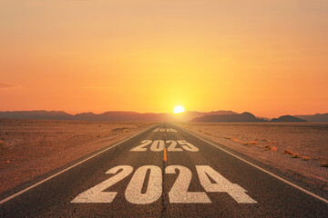 New year 2024 or straight forward concept. Text 2024 written on the road in the middle of asphalt...