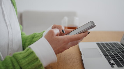 Woman hands texting mobile phone message room close up. Lady typing smartphone