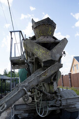 A concrete mixer delivers concrete for pouring the foundation.