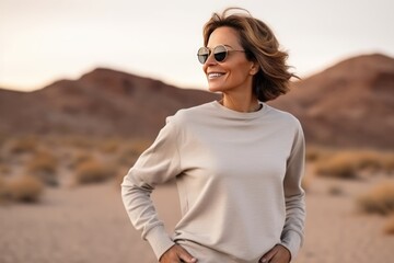 A Woman In A Sweatshirt In The Desert - obrazy, fototapety, plakaty