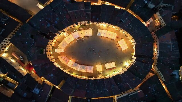 Aerial view of the main square, Piazza dell'Anfiteatro, in Lucca, night evening, Tuscany, Italy
