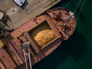 cargo ship or bulk carrier loaded to the brim with grain is prep
