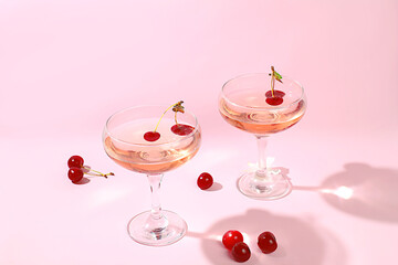 Modern still life with rose wine, alcoholic cocktail and cherry berries on elegant modern background, minimal concept for bar and holiday party, cafe, advertising banner, selective focus, - obrazy, fototapety, plakaty