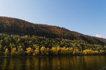 autumn colours in the mountains. landscape with lake. the autumn forest with yellowed leaves. Fall colours in the woods.