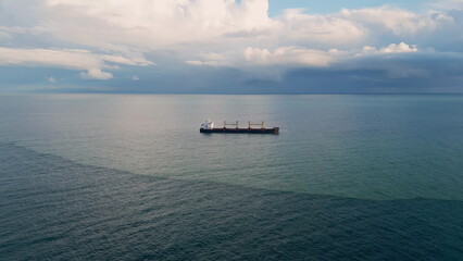 Aerial view ship sailing gloomy horizon slow motion. Vessel floating calm ocean
