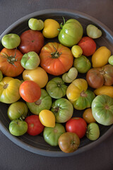 Plate with tomatoes in different degrees of ripeness
