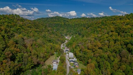 Fototapeta na wymiar Aerial view of a quaint town situated amongst a lush pine tree forest: Mountains of Eastern KY