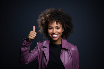Successful woman on a black background shows a sign of success, super. Space for your text