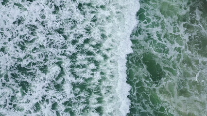 Stormy sea water crashing of sandy beach slow motion. Ocean waves surf rolling