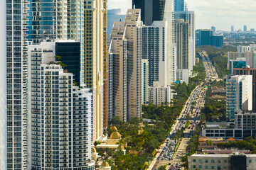 Aerial view of Sunny Isles Beach city with congested street traffic and luxurious highrise hotels and condos on Atlantic ocean shore. American tourism infrastructure in southern Florida