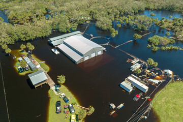 Flooded industrial business warehouse by hurricane Ian rainfall in Florida rural area. Consequences...
