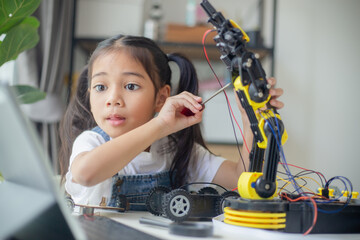 STEM education concept. Asian young girl learning robot design.