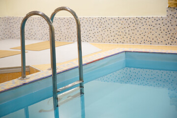 Indoor swimming pool with stainless steel ladder