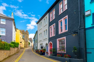 Schilderijen op glas Historic buildings painted vibrant colors line the streets of the Irish seaside village of Kinsale, a historic port and fishing town in County Cork, Ireland. © Kirk Fisher