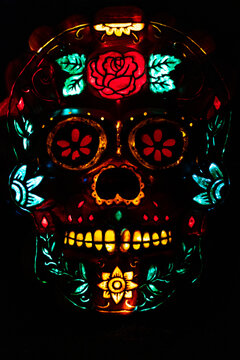 sugar skull made of pumpkins illuminated with colourful