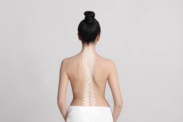 Woman with healthy back on light background. Illustration of spine - obrazy, fototapety, plakaty