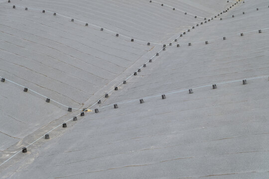 Lightning protection mesh on a soft rolled flat roof. Lightning protection rods at surface of industrial building roof.