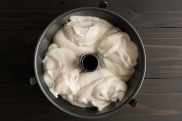 Angel Food Cake Batter in an Angel Food Cake Pan: Sponge cake batter in a nonstick metal tube pan or bundt pan with legs