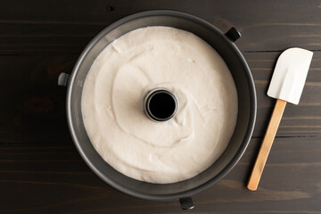 Angel Food Cake Batter in an Angel Food Cake Pan Smoothed with a Spatula: Sponge cake batter in a...