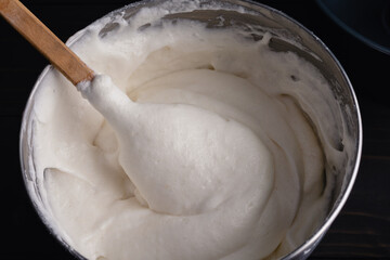 Freshly Mixed Angel Food Cake Batter in a Mixing Bowl: Egg whites and cake flour folded together to...