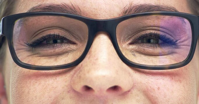Glasses, vision and portrait closeup of a woman in a studio with blue eyes with her pupils and cosmetic makeup. Macro zoom of a happy female person with optical eyesight spectacles for prescription.