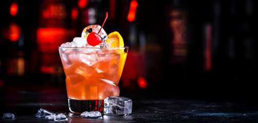 Matador cocktail drink with whiskey, vermouth, liqueur, bitter, grenadine, orange juice, cherry and...