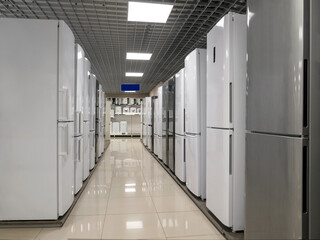 Rows of refrigerators in a home appliance and electronics store. The choice of refrigerators for buyers. Modern household appliances