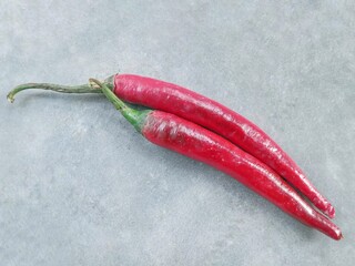 red curly chilies isolated on a gray background. herbs and spices. 