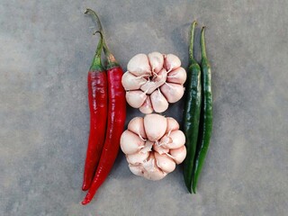 curly red chilies, garlic and curly green chilies isolated on a gray background. spices.
 - Powered by Adobe