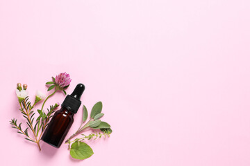 Obraz na płótnie Canvas Bottle of essential oil, different herbs and flowers on pink background, flat lay. Space for text