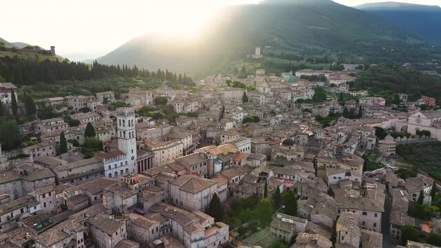 Aerial view of Assisi medieval town, Santa Maria sopra Minerva Church and Cathedral of San Rufino on a summer morning, Umbria, Italy
