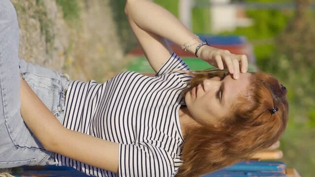 Vertical Video of Young woman fainting outdoors. Dizziness.