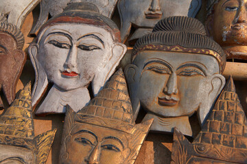 Fototapeta na wymiar Carved wooden heads of Buddha